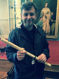 Gordon Turnbull holding an ivory flute.
