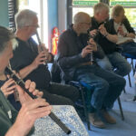A row of flute players playing flutes.